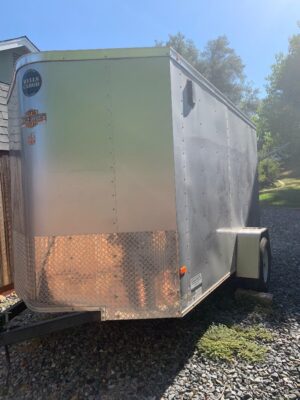 A trailer that is parked on the side of a road.