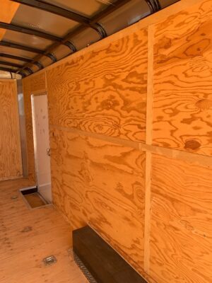 A room with plywood walls and floor.