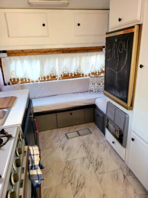 A kitchen with a chalkboard and window.