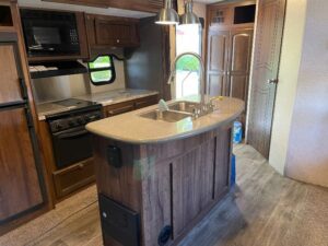 A kitchen with wood cabinets and a sink.