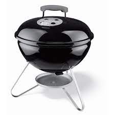 A black grill with a white handle and a black lid.