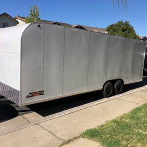 A trailer is parked on the side of the road.