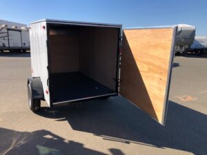 A trailer with the door open and its side closed.