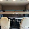 A bus with two seats and a table in the middle.