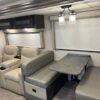 A couch and table in the back of an rv.