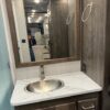 A bathroom with a sink and mirror in it