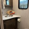 A bathroom with a sink, mirror and toilet.