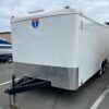 A white trailer parked in the parking lot.