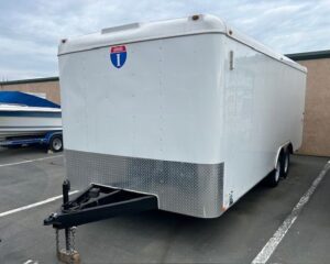 A white trailer parked in the parking lot.