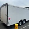 A white trailer parked in the parking lot.