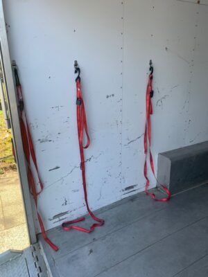 Three red straps hanging on a wall