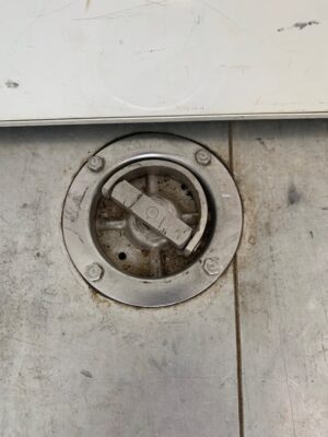 A close up of the floor drain on the ground