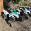 A group of four atv 's parked next to each other.